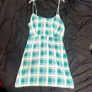 A green and white mini dress. Spaghetti straps and is plaid.